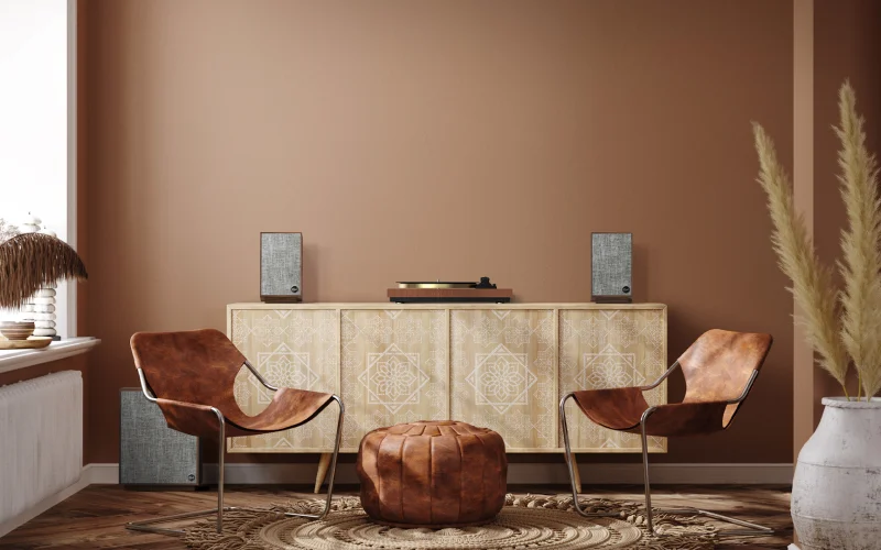 Klipsch-ProMedia-Heritage-2.1-speakers-in-a-home-next-to-a-record-player-with-2-chairs